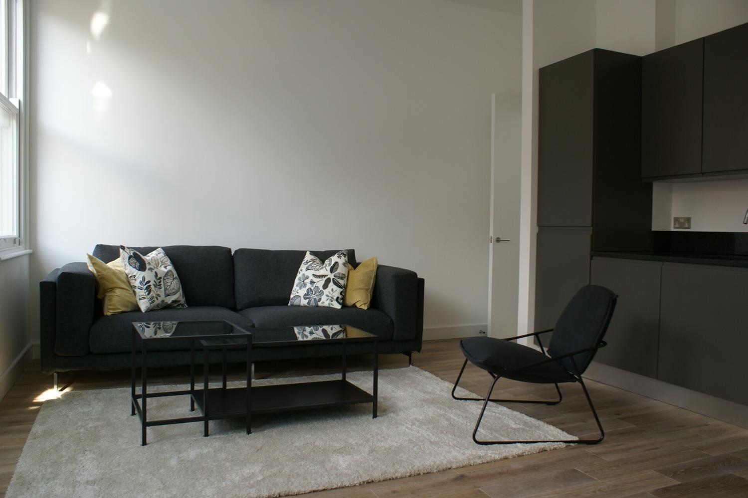 a living room filled with furniture and a tv