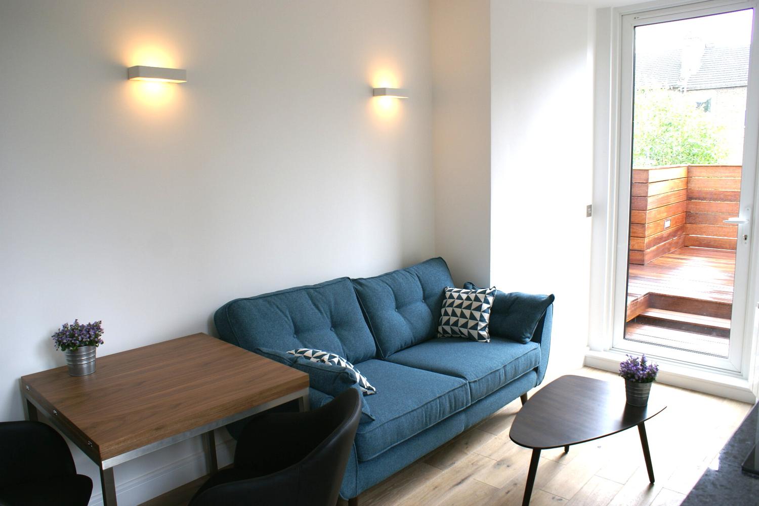 a living room filled with furniture and a large window