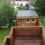 a wooden bench sitting in front of a house