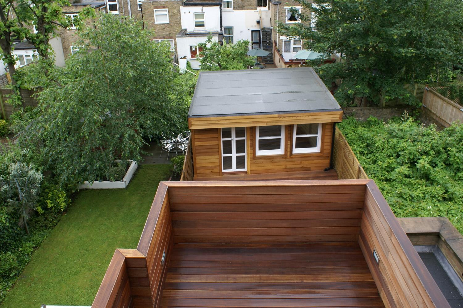 a wooden bench sitting in front of a house