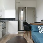 a living room filled with furniture and a stove