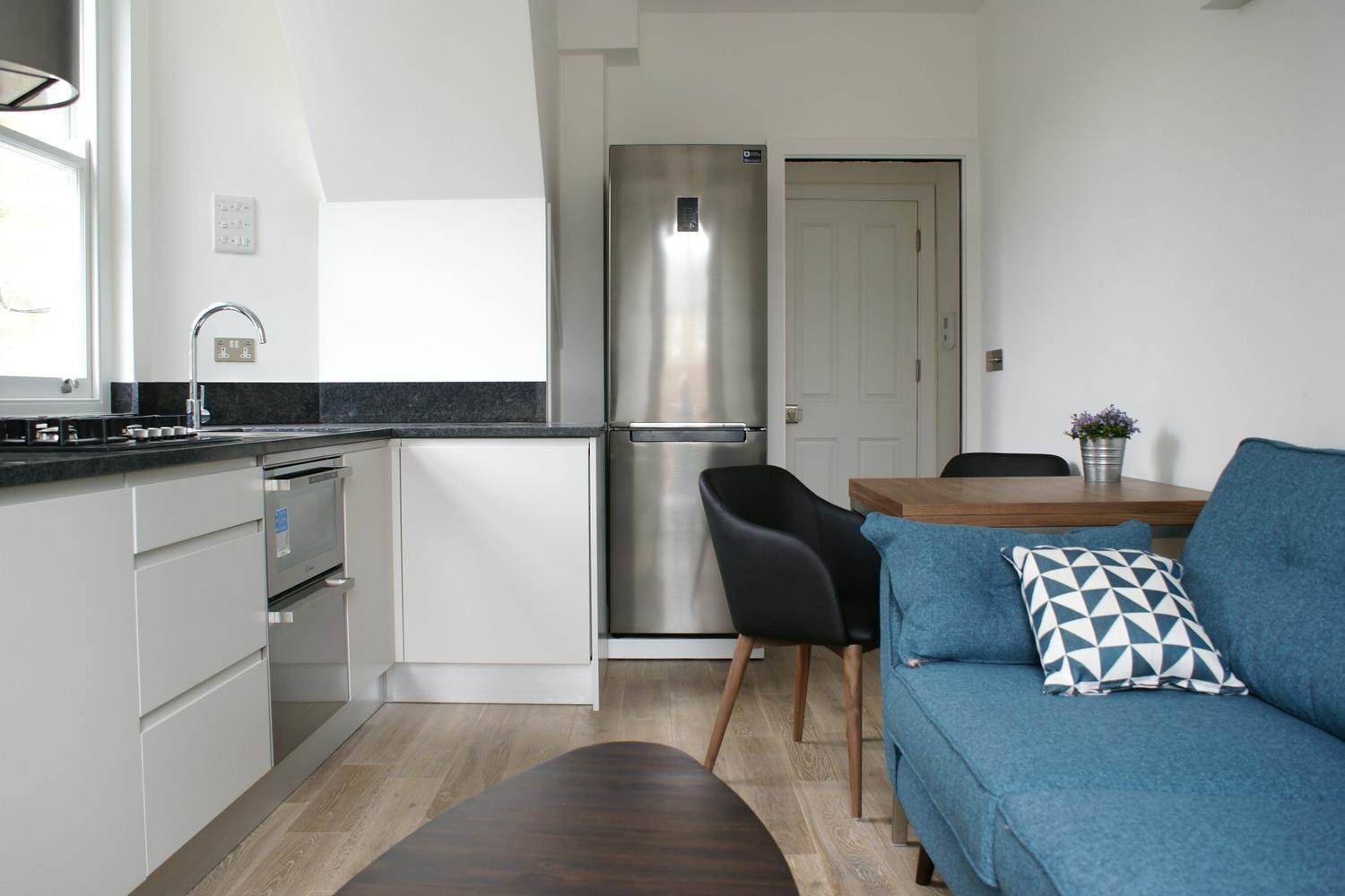 a living room filled with furniture and a stove