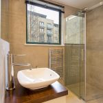 a glass shower door next to a sink