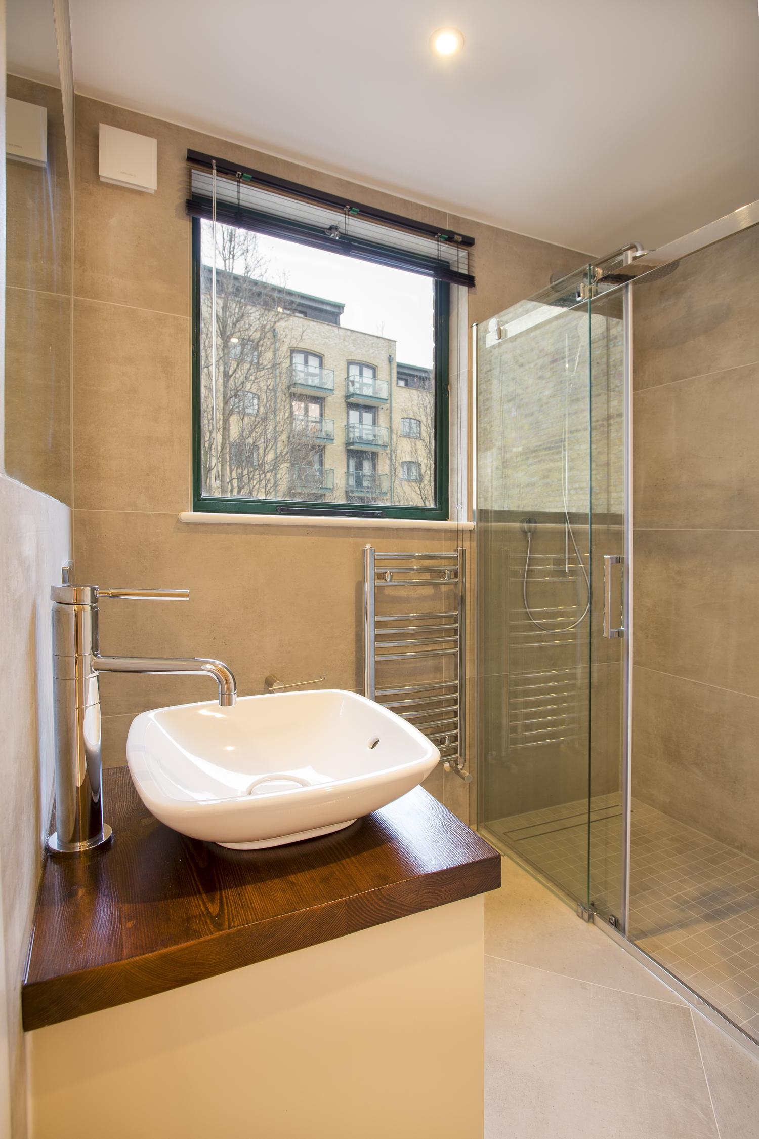 a glass shower door next to a sink