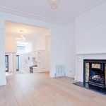 a living room filled with furniture and a fireplace