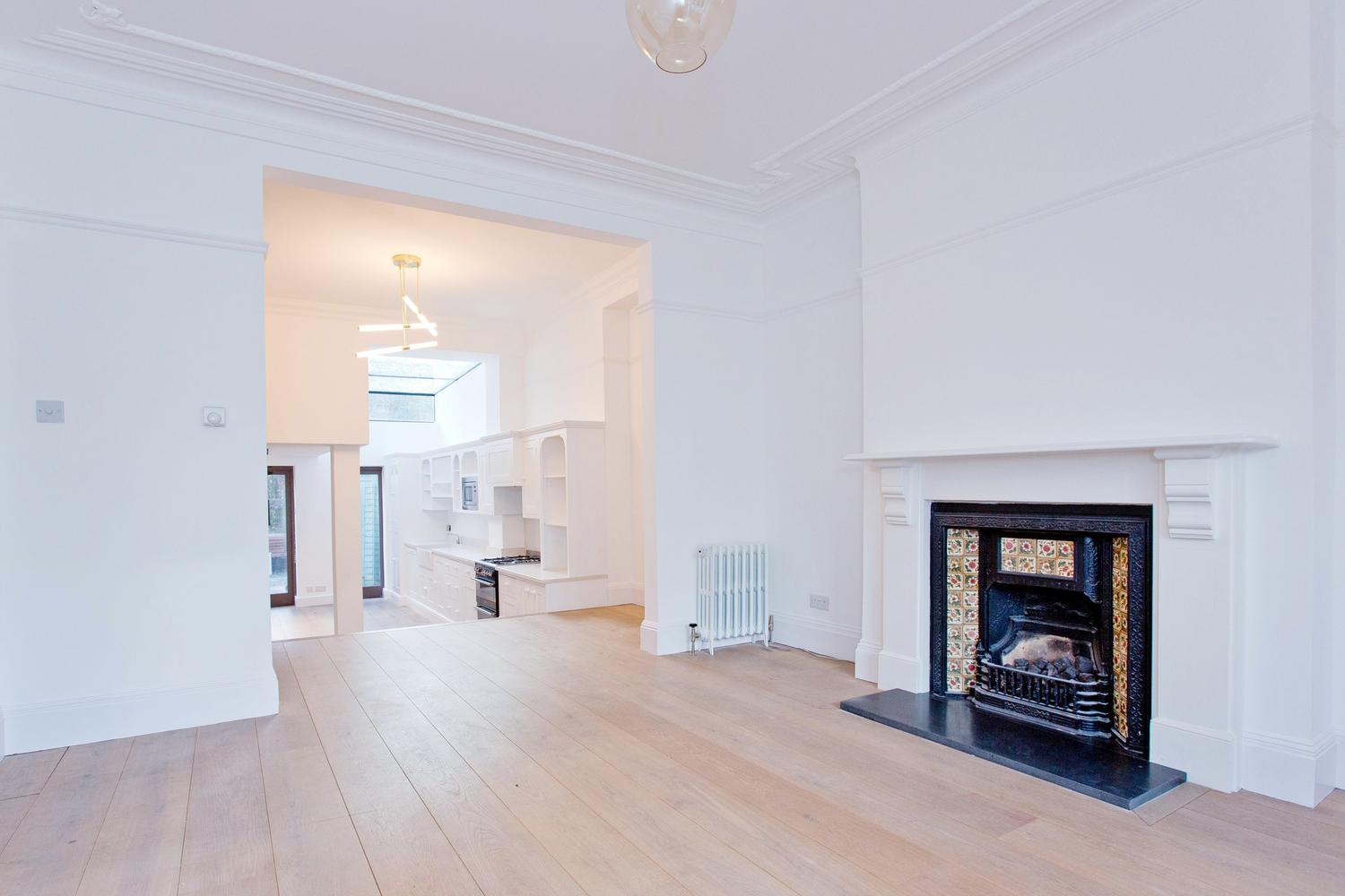 a living room filled with furniture and a fireplace