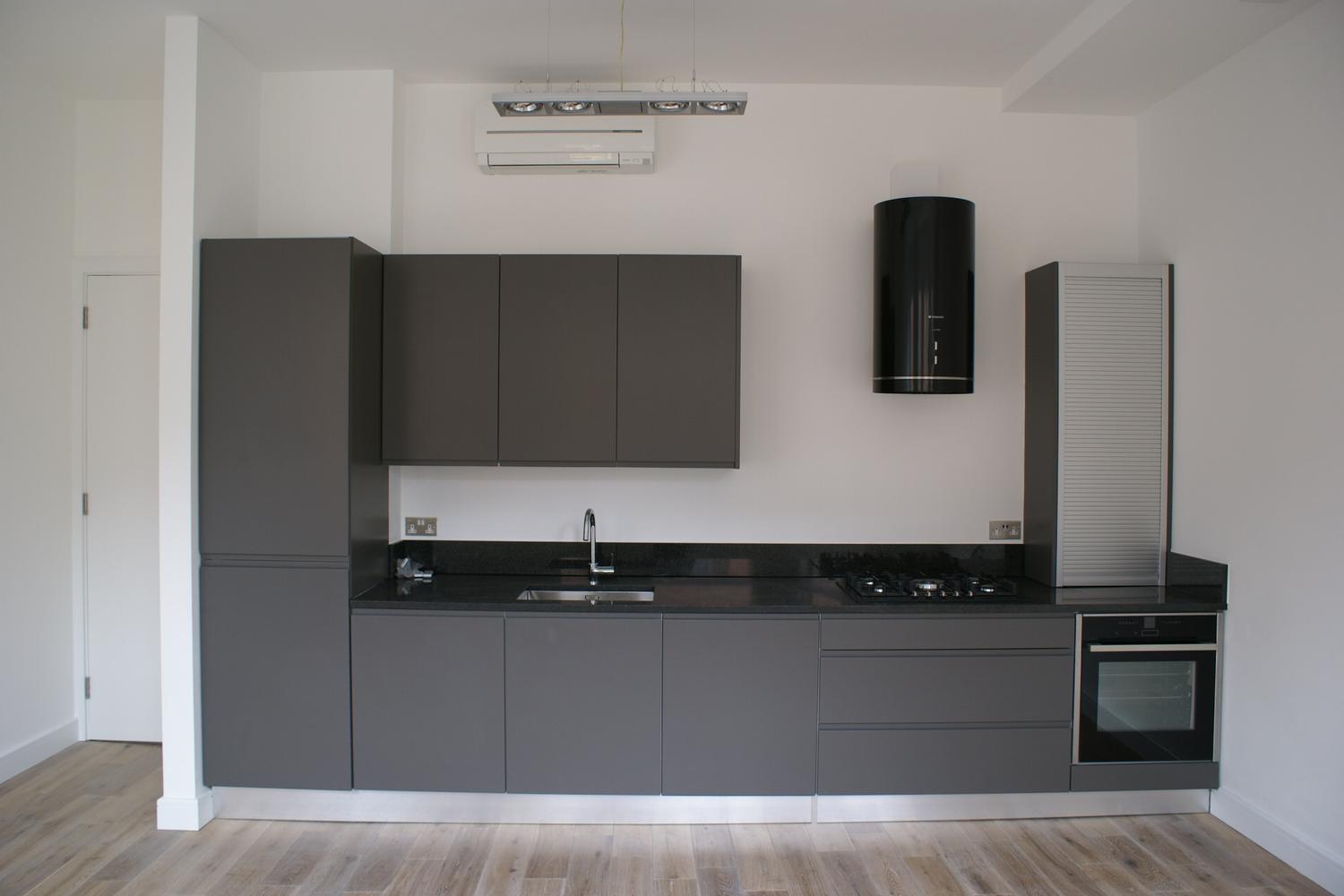 a kitchen with a sink and a mirror