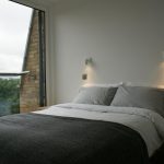 a bedroom with a large bed sitting next to a window