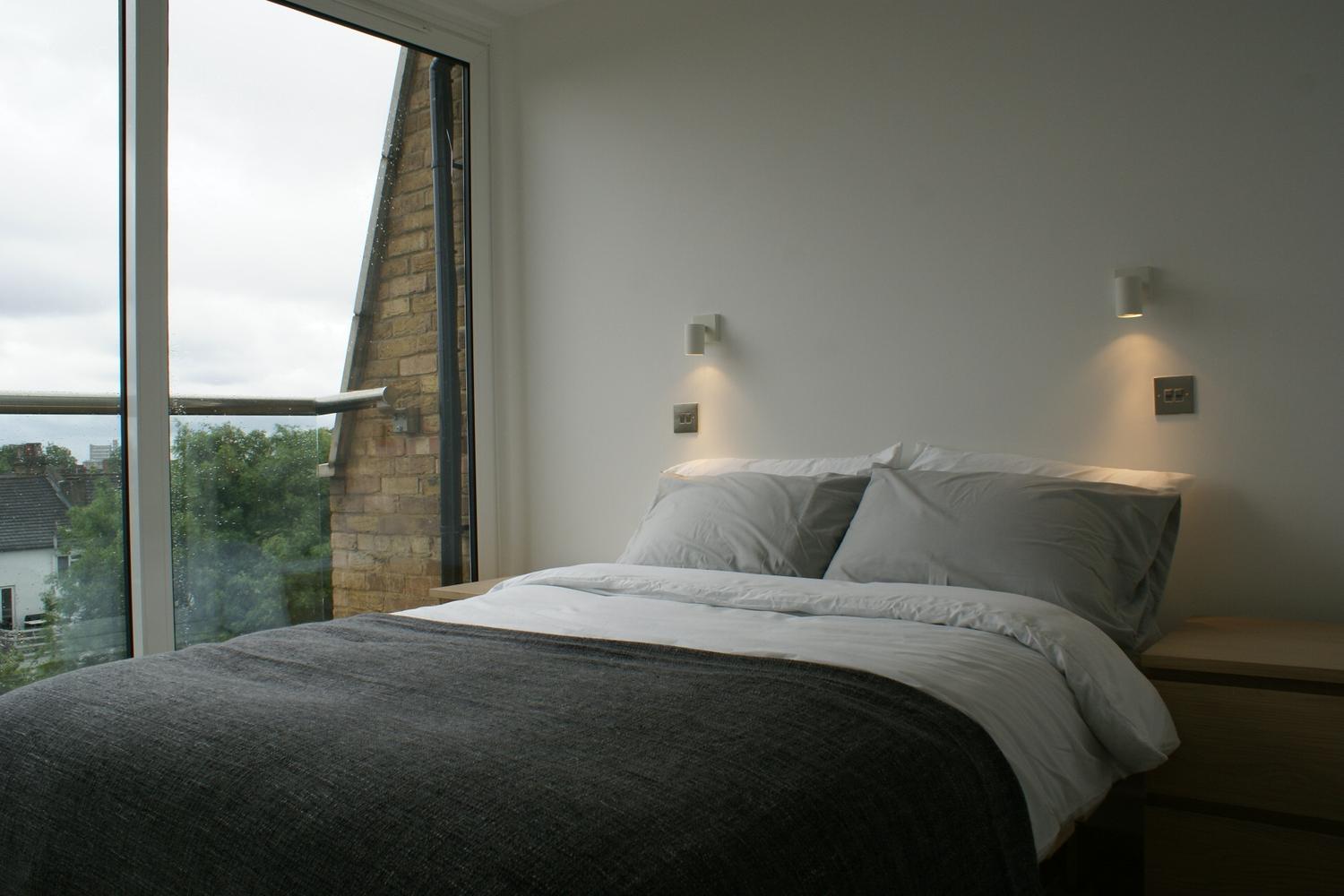 a bedroom with a large bed sitting next to a window