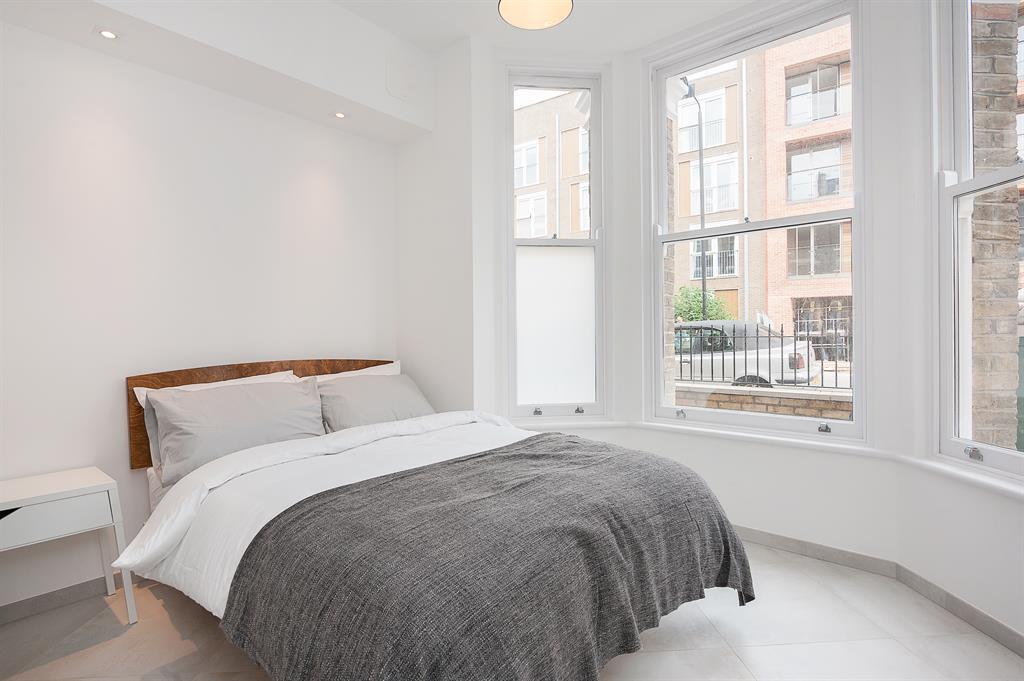 a bedroom with a bed and window in a room