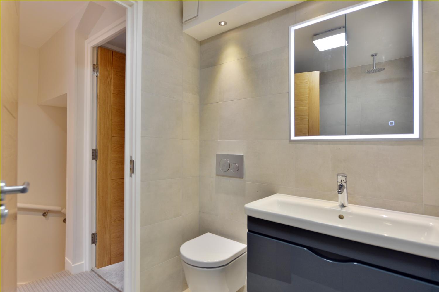 a shower that has a sink and a mirror