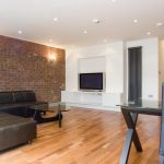 a living room filled with furniture and a flat screen tv