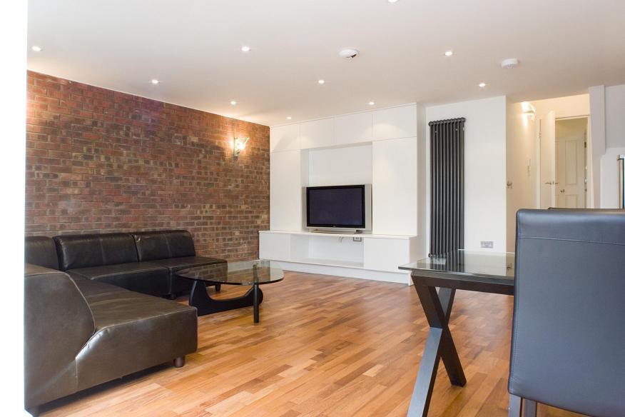 a living room filled with furniture and a flat screen tv