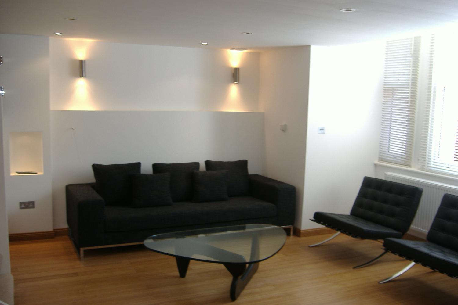 a living room filled with furniture and a flat screen tv