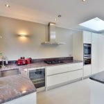 Modern kitchen design including a sink, a stove and an extractor hood