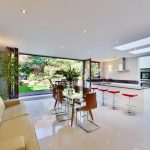 Open plan kitchen with a beige couch Stunning kitchen with stove countertop