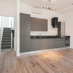 Large kitchen with a door open to the stairs