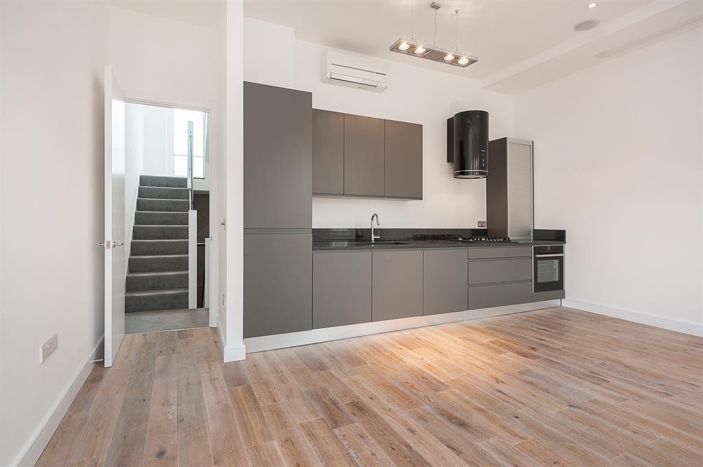 Large kitchen with a door open to the stairs
