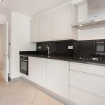 Closed kitchen design with a white door