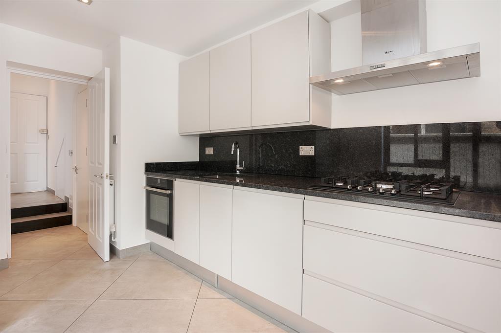 Closed kitchen design with a white door