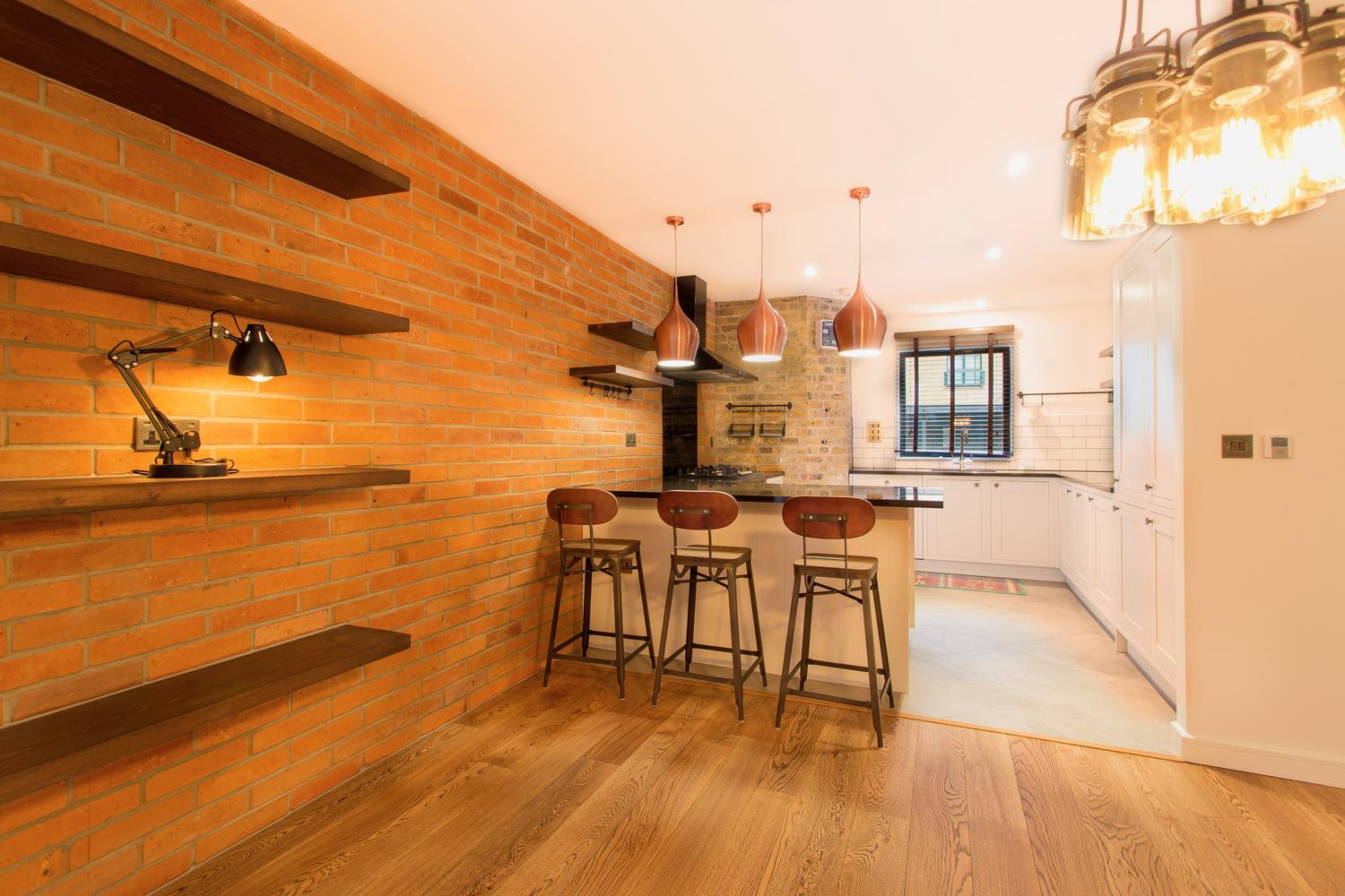 Open plan kitchen design with wood wall and floor