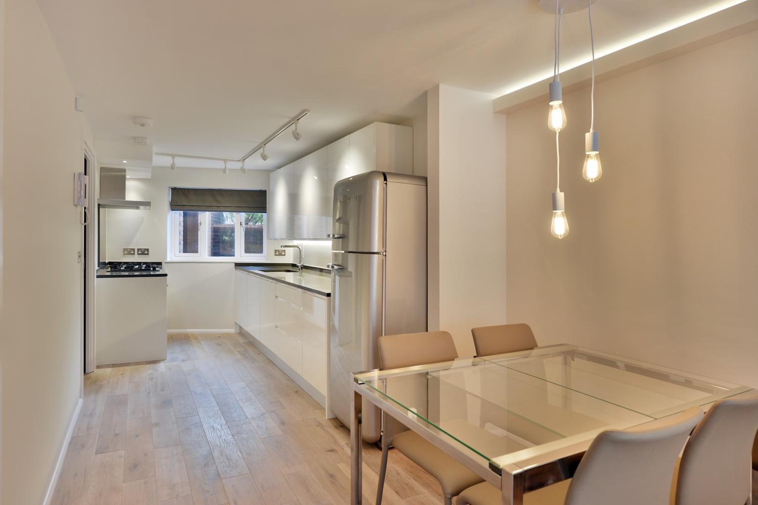 Closed kitchen design with a small dining table