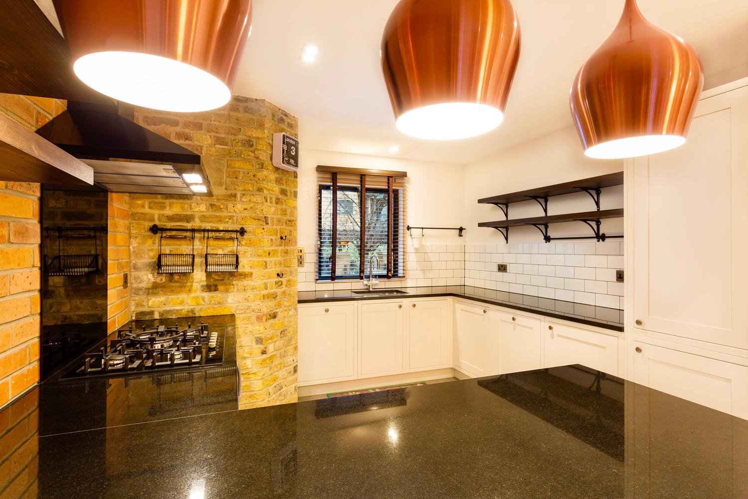 Kitchen design with white cabinets and wood wall