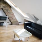 a living room filled with furniture and a wood floor