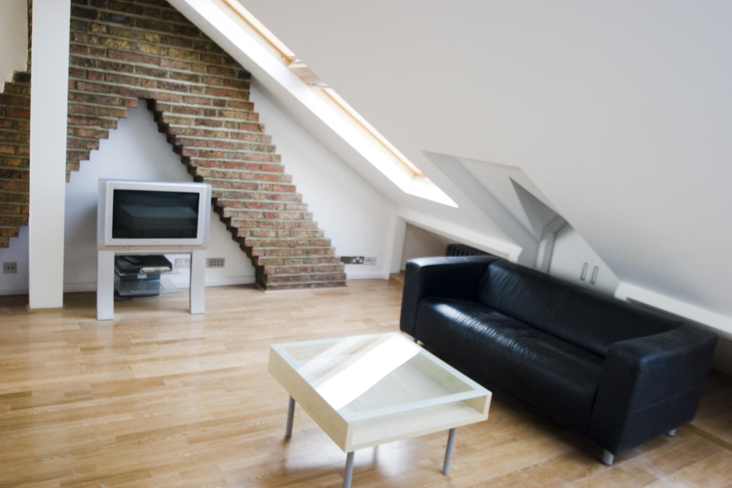 a living room filled with furniture and a wood floor