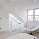 a bedroom with a large tub next to a window