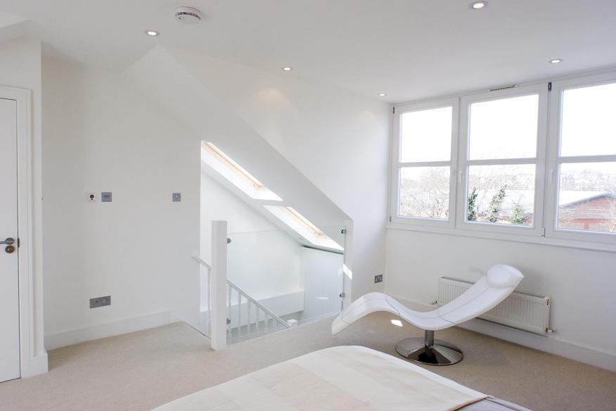 a bedroom with a large tub next to a window