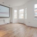 a close up of a hard wood floor next to a window