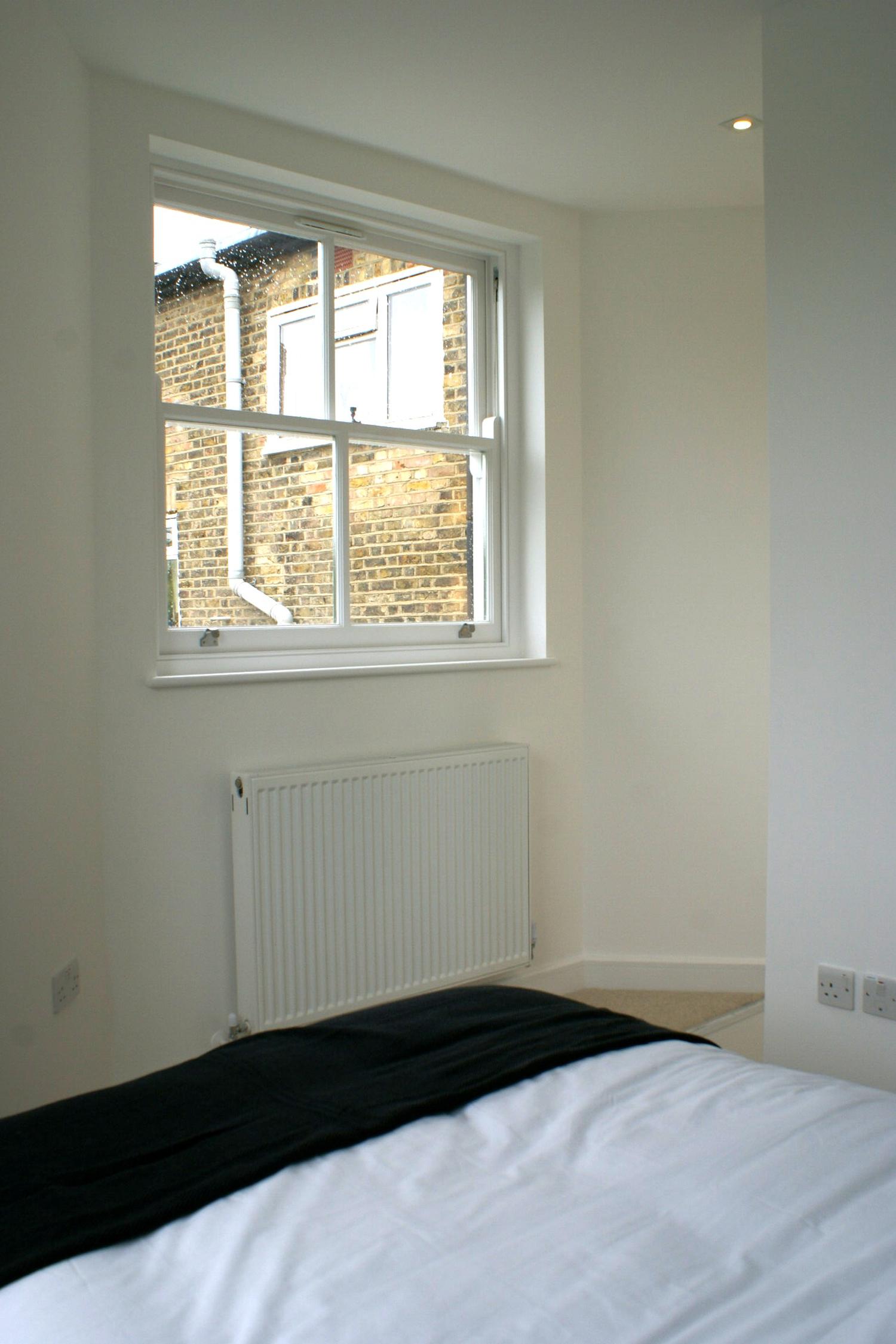 a bedroom with a bed and a window