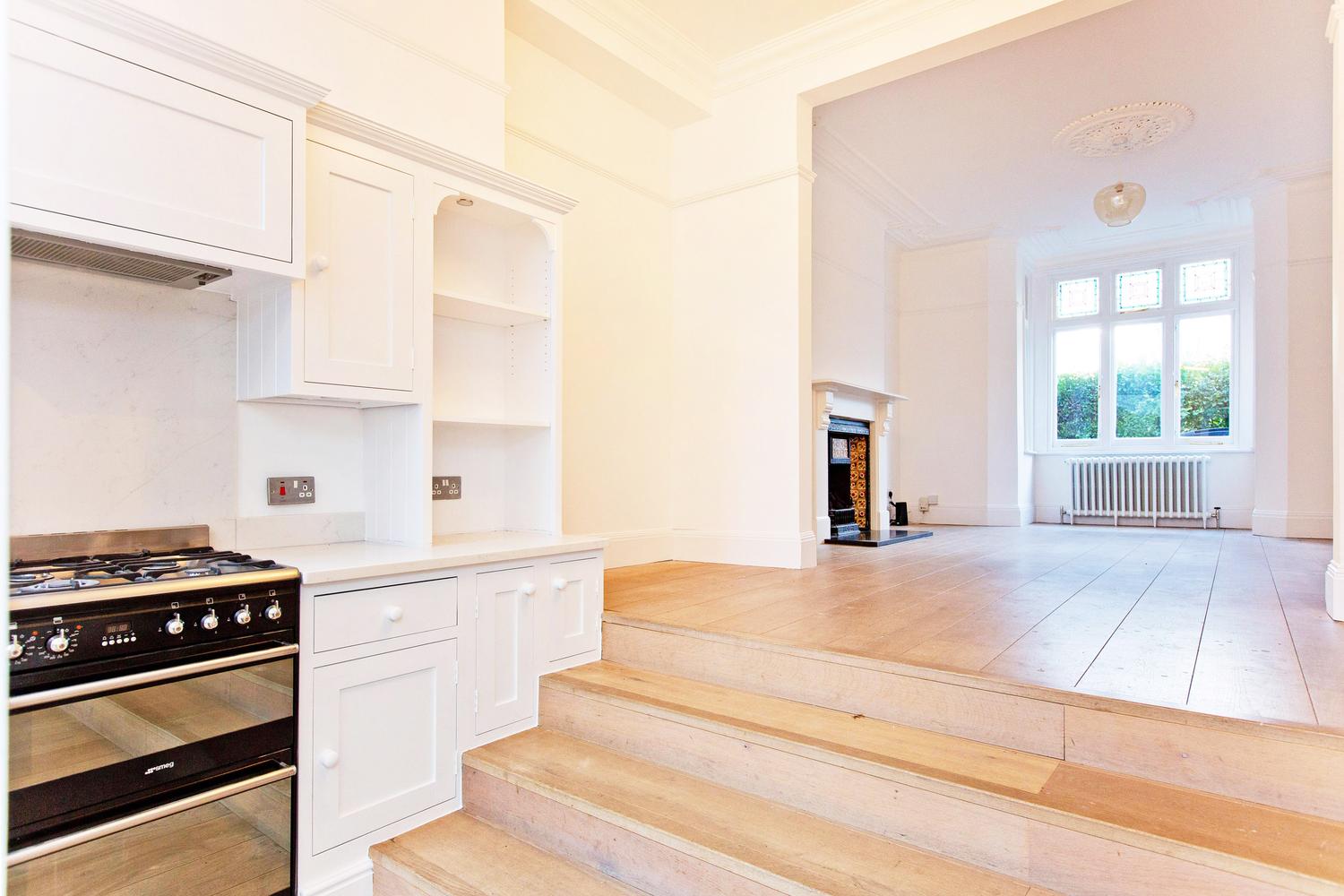 a stove top oven sitting inside of a kitchen