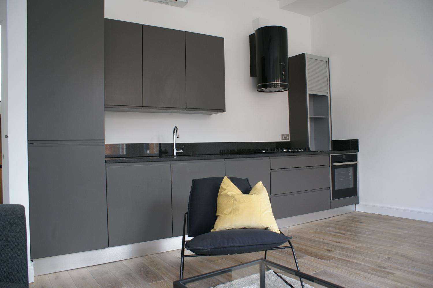 a living room filled with furniture and a flat screen tv