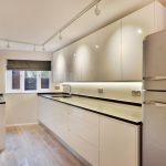 a kitchen with a stove sink and refrigerator