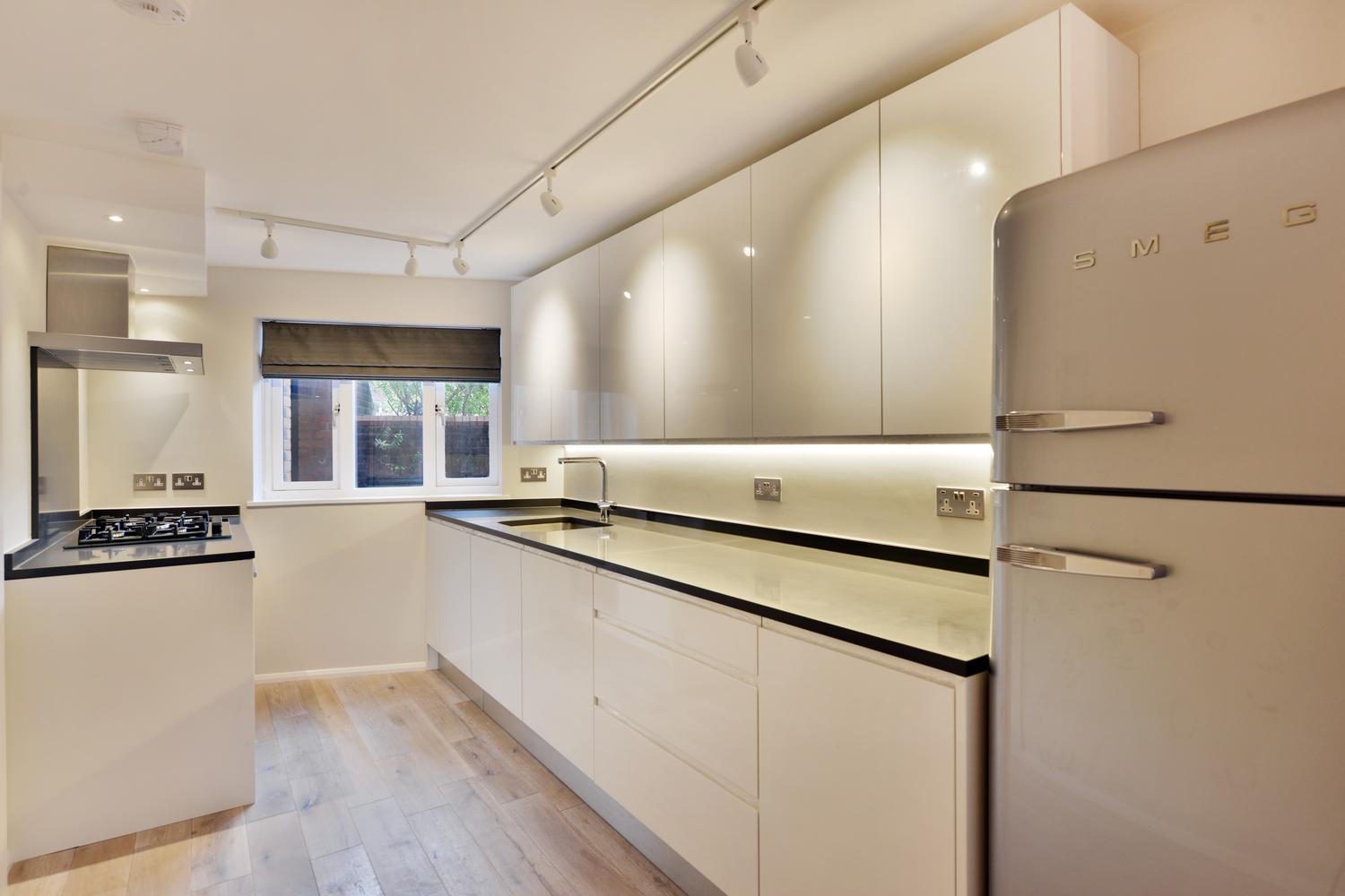 a kitchen with a stove sink and refrigerator