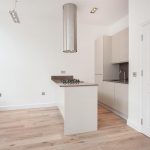 a kitchen with a sink and a mirror