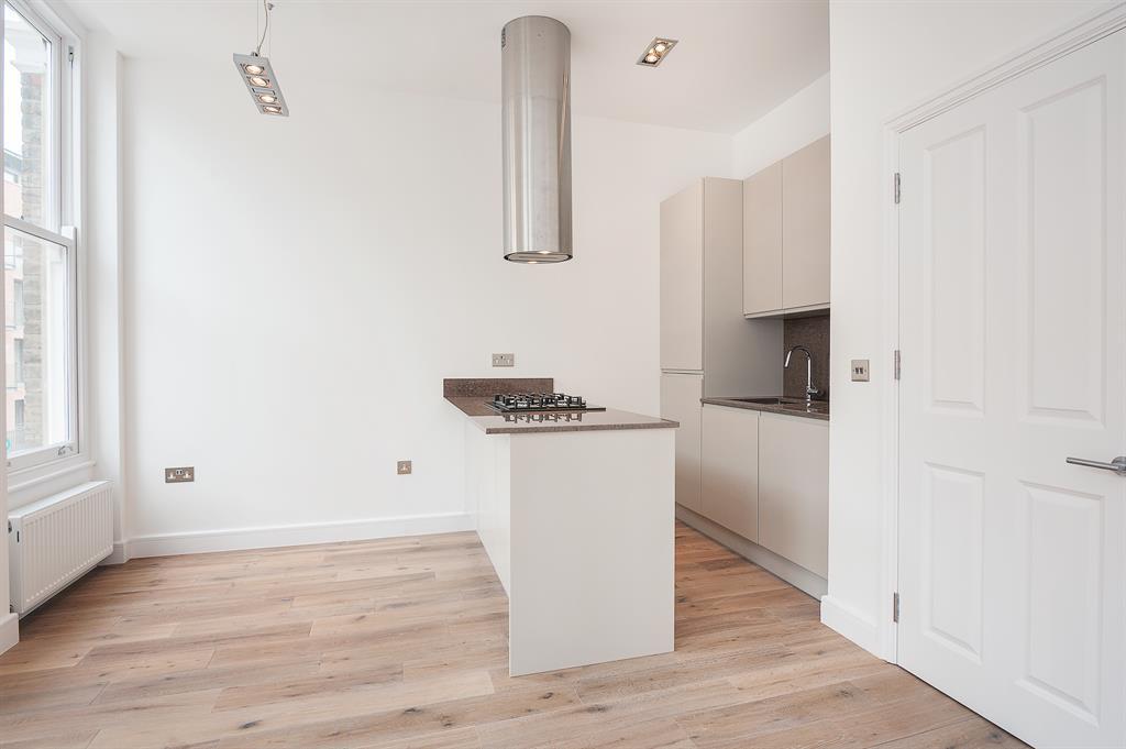 a kitchen with a sink and a mirror