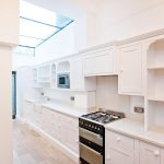 a stove top oven sitting inside of a kitchen