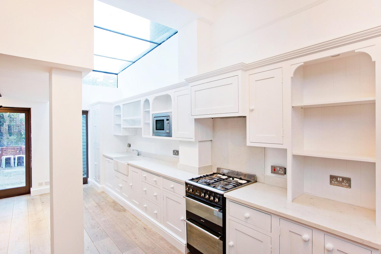 a stove top oven sitting inside of a kitchen