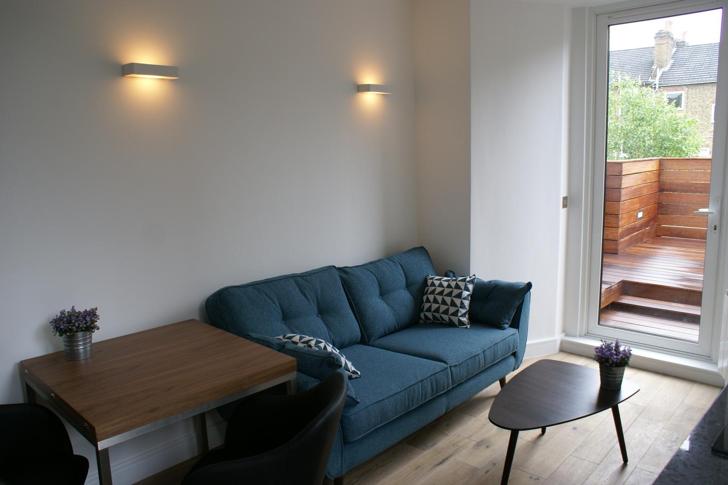 a living room filled with furniture and a large window